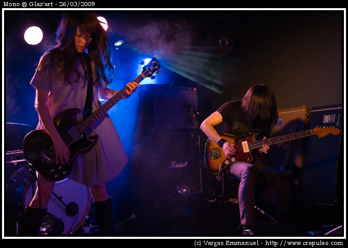 Mono @ Glaz'art Photo 9 - Mono Live in Paris @ Glaz'art for the "hymn to the immortal wind" tour. 2009-03-26.
Mono were founded in January 2000 by guitarist Takaakira Goto. The first member to join was fellow guitarist and long time friend Yoda. Soon afterwards the two guitarists linked up with bassist Tamaki and drummer Yasunori Takada.
All of Mono's songs are entirely instrumental, and Strings and pianos are also prominently featured in several songs.
In 2002, Mono finished their second album, One Step More and You Die. Many critics considered this as having a more distinctive sound than the preceding album.
Soon afterward, Mono moved on to a new project in direct response to the aftermath of September 11th. This album was titled New York Soundtracks and was recorded in collaboration with several important members of the New York experimental scene, such as DJ Olive, Jackie-O Motherfucker, and Loren Connors. New York Soundtracks consists of remixes of all of One Step More and You Die's tracks.
Following Soundtracks, Mono embarked on the production of their next album, Walking Cloud and Deep Red Sky, Flag Fluttered and the Sun Shined which was released on October 5, 2004. Following the release of this album, Mono began a lengthy world tour.
On June 24, 2006, Mono released their next album, You Are There. You Are There met similar success to Palmless Prayer / Mass Murder Refrain and was accompanied by worldwide tours throughout 2006 and 2007.
Mono, like most bands associated with the underground music scene, tries to maintain a strong relationship with their fans. Goto, in a recent interview with Semtex Magazine, pointed out that for Mono, promotion is not a priority, they tour "to meet the crowd". 20090326_Mono_09.jpg
