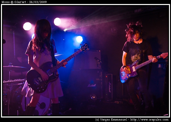Mono @ Glaz'art Photo 14 - Mono Live in Paris @ Glaz'art for the "hymn to the immortal wind" tour. 2009-03-26.
Mono were founded in January 2000 by guitarist Takaakira Goto. The first member to join was fellow guitarist and long time friend Yoda. Soon afterwards the two guitarists linked up with bassist Tamaki and drummer Yasunori Takada.
All of Mono's songs are entirely instrumental, and Strings and pianos are also prominently featured in several songs.
In 2002, Mono finished their second album, One Step More and You Die. Many critics considered this as having a more distinctive sound than the preceding album.
Soon afterward, Mono moved on to a new project in direct response to the aftermath of September 11th. This album was titled New York Soundtracks and was recorded in collaboration with several important members of the New York experimental scene, such as DJ Olive, Jackie-O Motherfucker, and Loren Connors. New York Soundtracks consists of remixes of all of One Step More and You Die's tracks.
Following Soundtracks, Mono embarked on the production of their next album, Walking Cloud and Deep Red Sky, Flag Fluttered and the Sun Shined which was released on October 5, 2004. Following the release of this album, Mono began a lengthy world tour.
On June 24, 2006, Mono released their next album, You Are There. You Are There met similar success to Palmless Prayer / Mass Murder Refrain and was accompanied by worldwide tours throughout 2006 and 2007.
Mono, like most bands associated with the underground music scene, tries to maintain a strong relationship with their fans. Goto, in a recent interview with Semtex Magazine, pointed out that for Mono, promotion is not a priority, they tour "to meet the crowd". 20090326_Mono_14.jpg